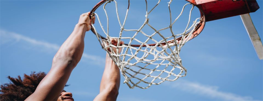 man-hanging-from-basketball-net.jpg